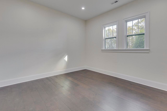 unfurnished room featuring dark wood-type flooring