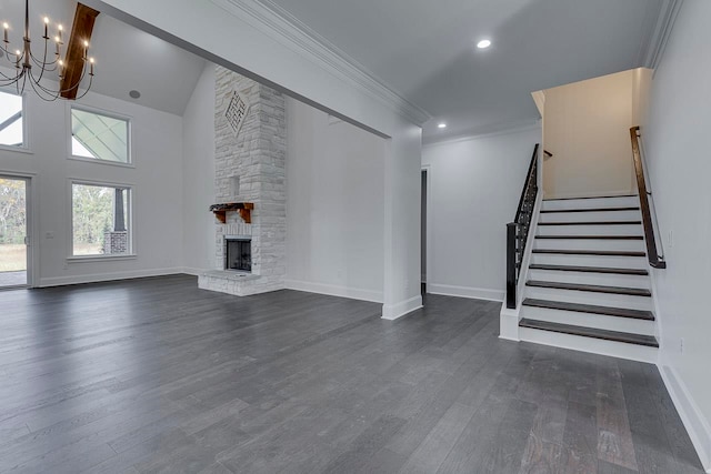 unfurnished living room featuring a stone fireplace, dark hardwood / wood-style flooring, ornamental molding, and a notable chandelier