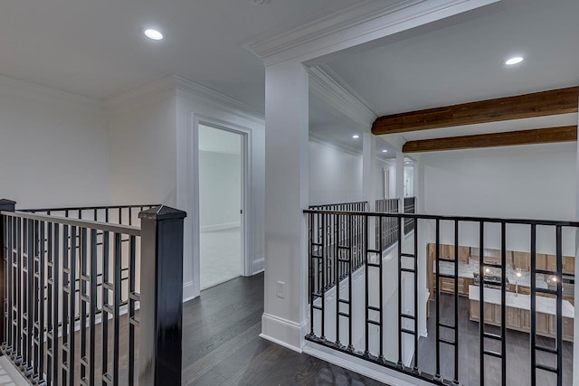 corridor featuring beam ceiling, crown molding, and dark wood-type flooring