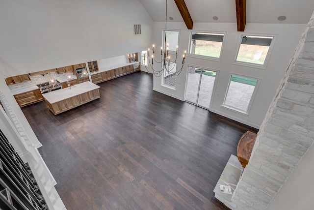 entrance foyer with beamed ceiling, dark hardwood / wood-style flooring, a chandelier, and high vaulted ceiling