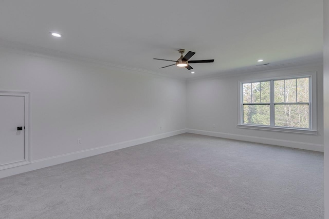 carpeted empty room with ceiling fan and crown molding