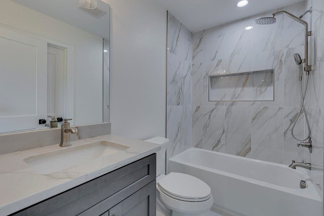 full bathroom featuring toilet, vanity, and tiled shower / bath