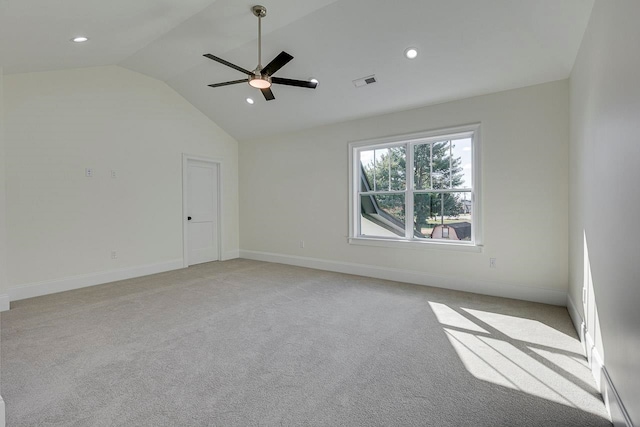 carpeted empty room with vaulted ceiling and ceiling fan