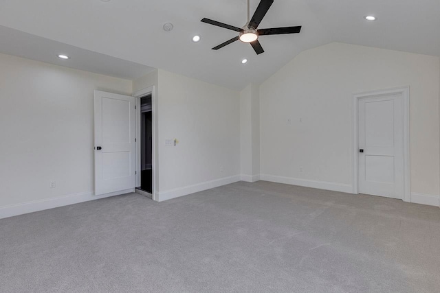 carpeted empty room with vaulted ceiling and ceiling fan