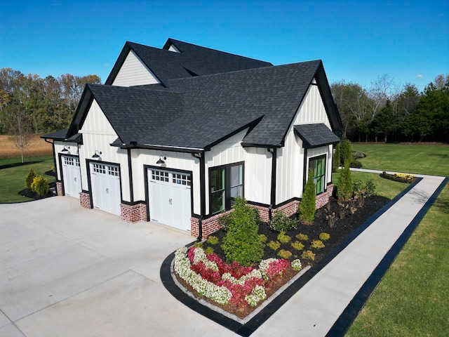 view of side of property featuring a yard and a garage