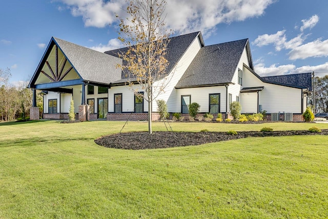 rear view of property with a lawn