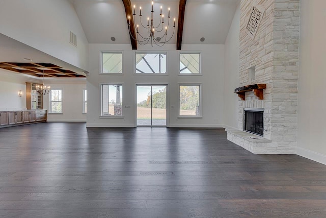 unfurnished living room featuring a stone fireplace, plenty of natural light, and dark wood-type flooring