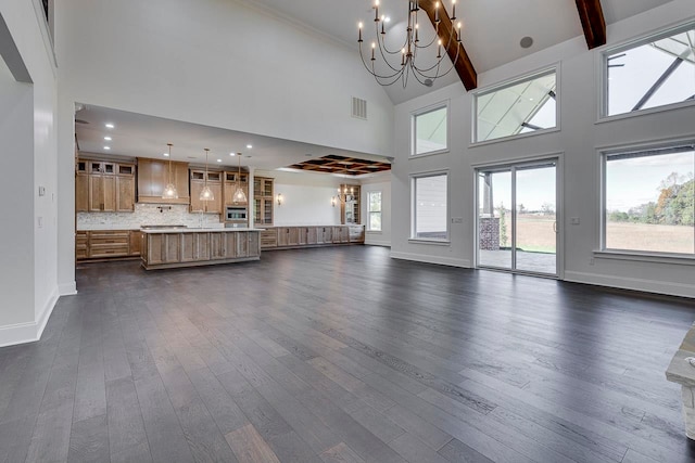 unfurnished living room with beamed ceiling, high vaulted ceiling, dark wood-type flooring, and a notable chandelier