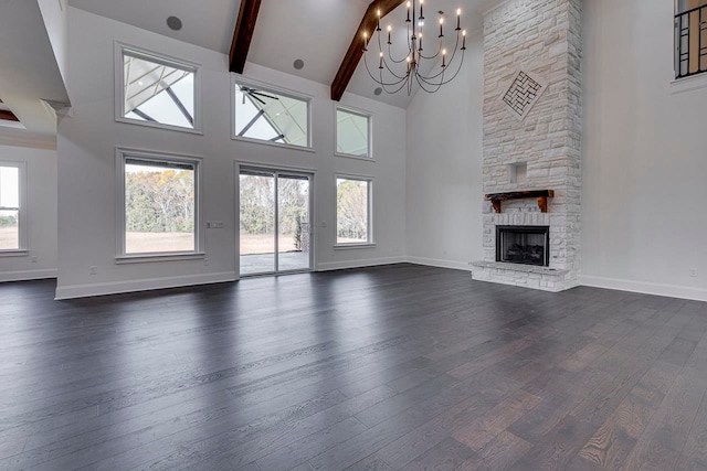 unfurnished living room featuring beamed ceiling, high vaulted ceiling, dark hardwood / wood-style floors, a chandelier, and a fireplace