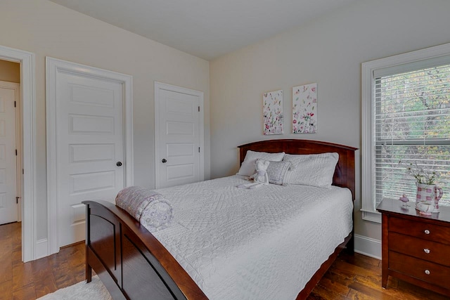 bedroom with dark hardwood / wood-style floors