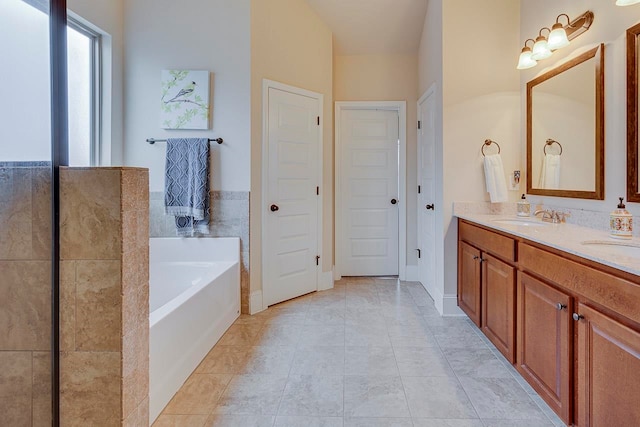 bathroom featuring vanity, tile patterned floors, and a bathtub