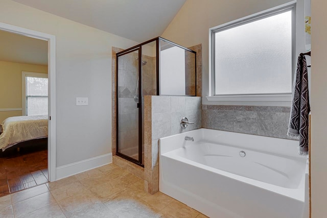 bathroom with shower with separate bathtub and tile patterned floors