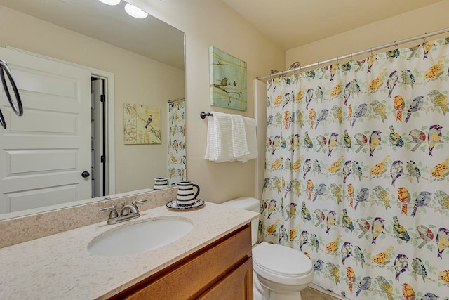 bathroom featuring vanity, toilet, and curtained shower