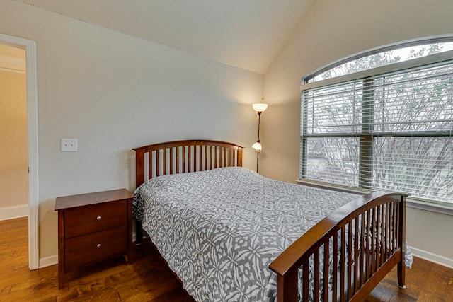 bedroom with dark wood-type flooring and vaulted ceiling