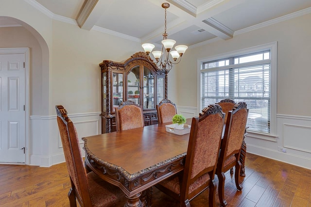 dining area featuring a wealth of natural light, crown molding, and wood-type flooring