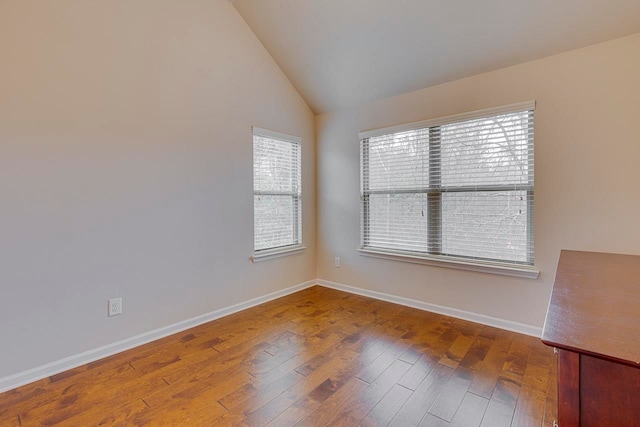 unfurnished room with wood-type flooring and vaulted ceiling