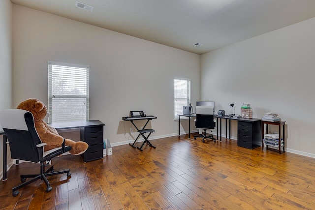 home office featuring hardwood / wood-style flooring and a healthy amount of sunlight