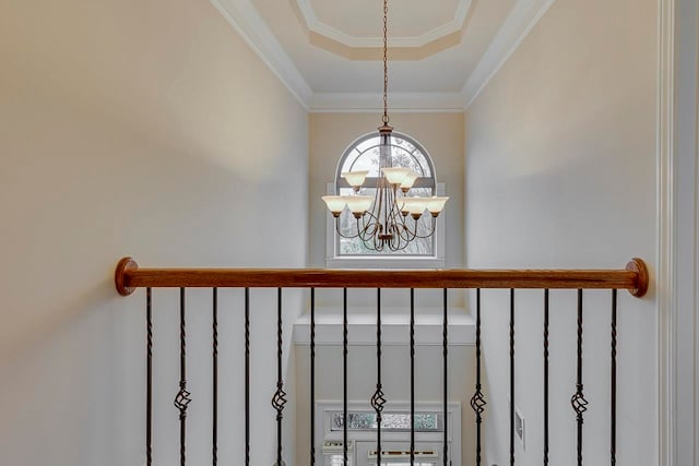 room details featuring a notable chandelier, a raised ceiling, and crown molding