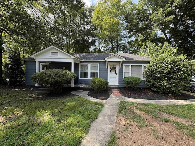 bungalow-style home featuring a front yard