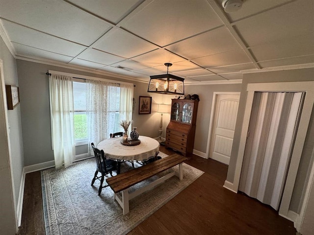 dining room with ornamental molding, dark wood-style flooring, coffered ceiling, and baseboards