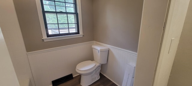 bathroom featuring hardwood / wood-style flooring and toilet