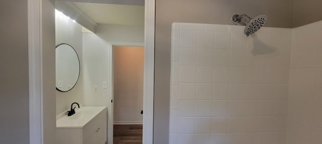 bathroom featuring vanity, hardwood / wood-style flooring, and walk in shower