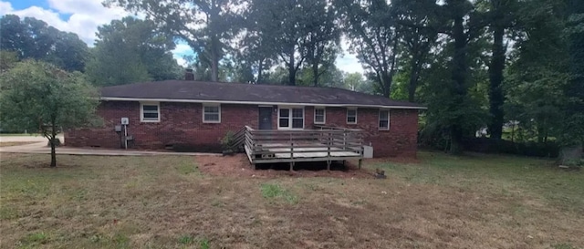 back of house with a yard and a wooden deck