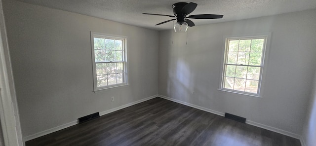 empty room with ceiling fan and dark hardwood / wood-style flooring