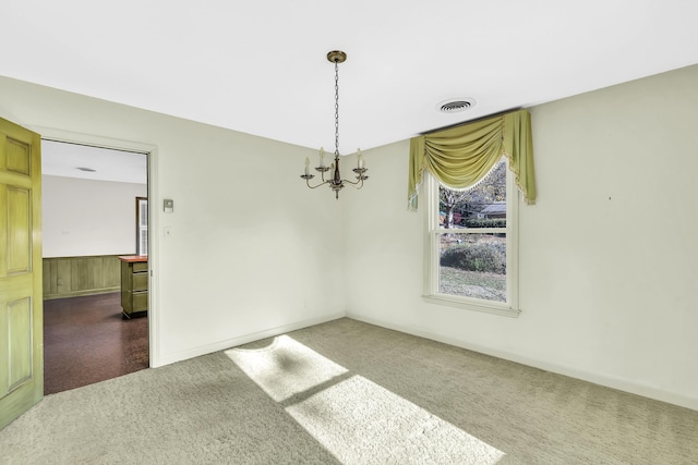 unfurnished dining area featuring carpet floors and a notable chandelier