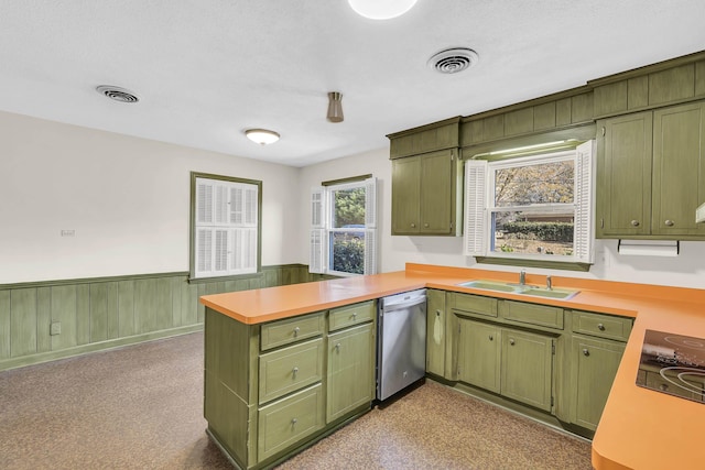 kitchen with stainless steel dishwasher, green cabinets, kitchen peninsula, and sink