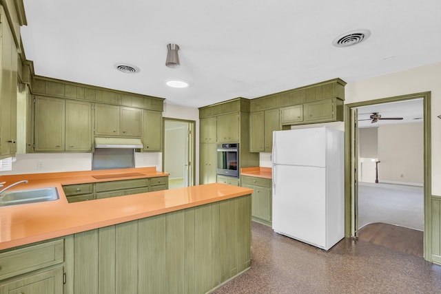 kitchen featuring stainless steel oven, black electric cooktop, sink, white refrigerator, and green cabinetry