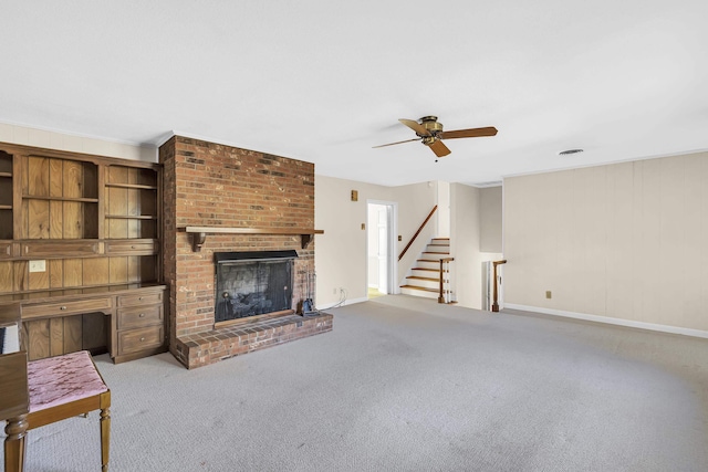 unfurnished living room with ceiling fan, light colored carpet, and a brick fireplace