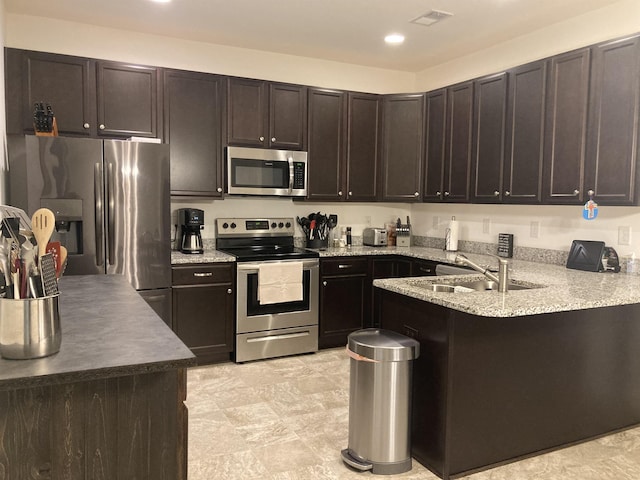 kitchen featuring dark brown cabinets and appliances with stainless steel finishes