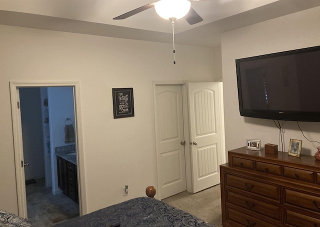 carpeted bedroom featuring ceiling fan and ensuite bathroom