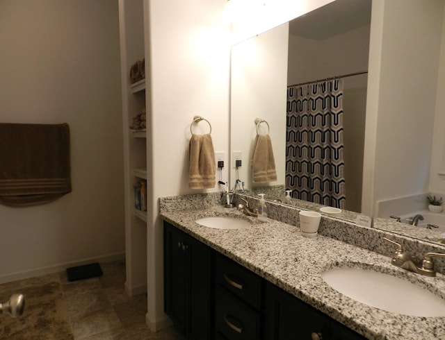 bathroom with a washtub and vanity