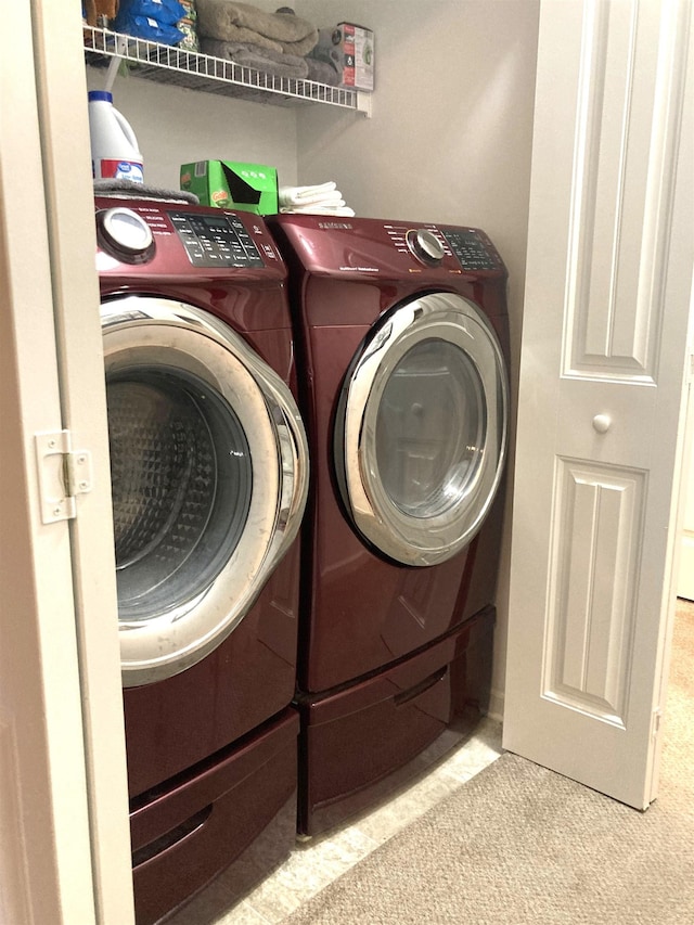 laundry room featuring light colored carpet and washing machine and clothes dryer