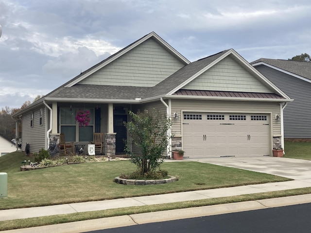 craftsman-style home featuring a garage and a front yard