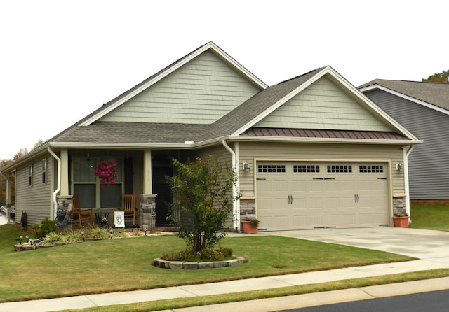 craftsman-style home with a porch, a garage, and a front lawn