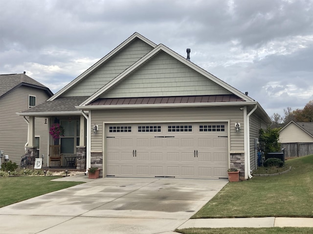 craftsman-style house with a porch, a garage, and a front lawn