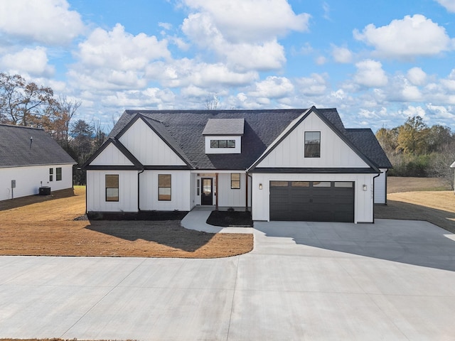 modern farmhouse with a garage, central air condition unit, and a front yard