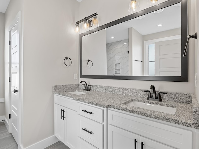 bathroom with vanity and a shower