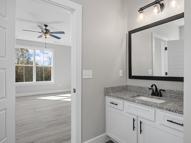 bathroom featuring hardwood / wood-style flooring, vanity, and ceiling fan