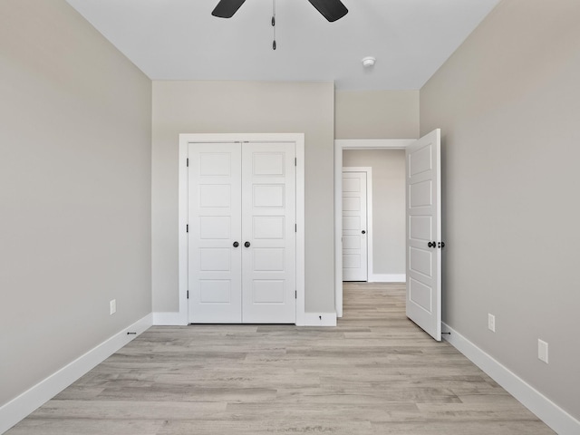 unfurnished bedroom with a closet, light hardwood / wood-style floors, and ceiling fan