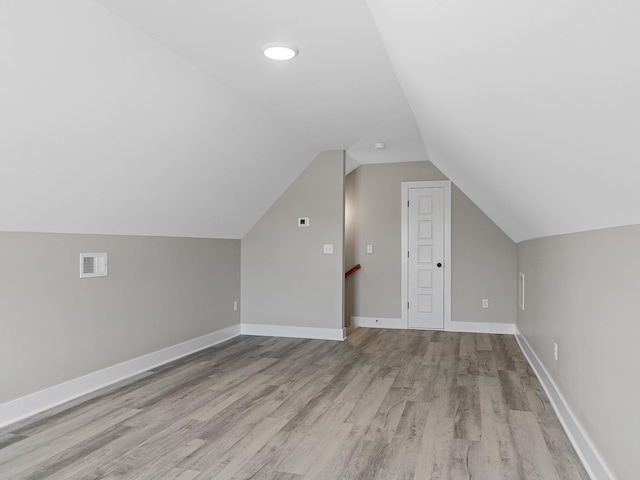 bonus room featuring light hardwood / wood-style flooring and vaulted ceiling