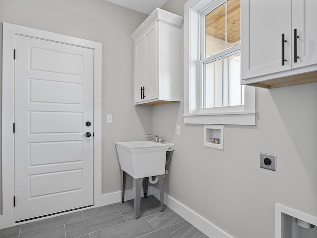 washroom with electric dryer hookup, cabinets, and hookup for a washing machine