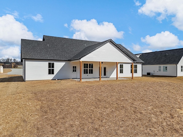 rear view of property with ceiling fan and a patio