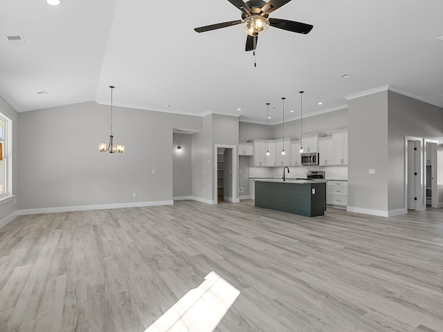 unfurnished living room with crown molding, light hardwood / wood-style flooring, ceiling fan with notable chandelier, and sink