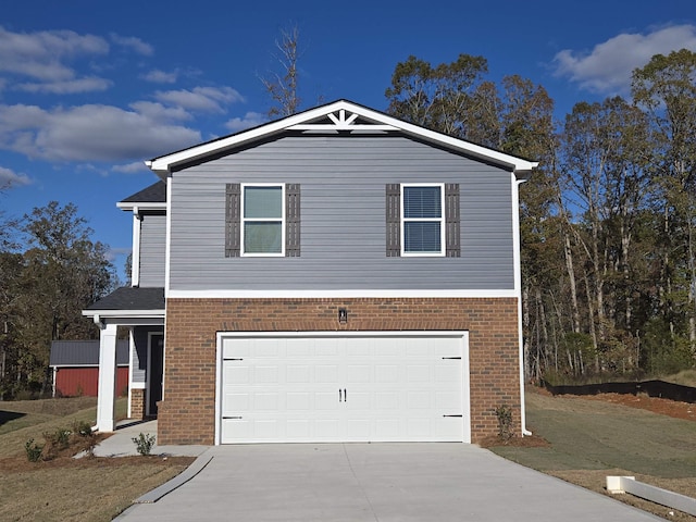 view of front of property with driveway, an attached garage, and brick siding