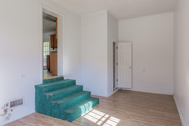 stairs featuring hardwood / wood-style floors