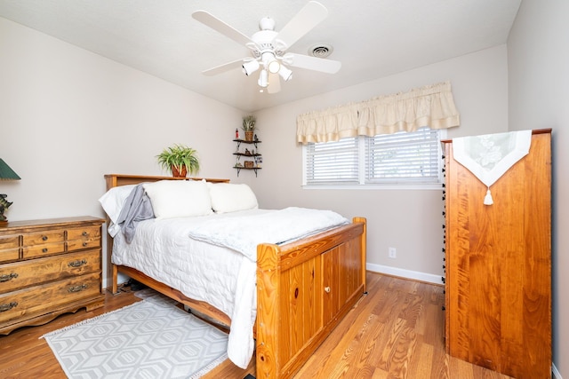 bedroom with ceiling fan and light wood-type flooring